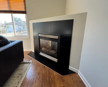 Cozy living room with black modern fireplace and comfortable seating
