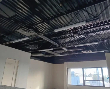 Large industrial warehouse with high ceiling and metal beams.